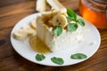 Portion of homemade milk curd with banana slices and honey