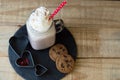 Portion of hot chocolate with whipped cream topping and red stra Royalty Free Stock Photo