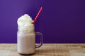 Portion of hot chocolate with white whipped cream in a glass jar Royalty Free Stock Photo