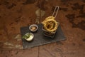 Portion of huge onion rings battered and fried in olive oil with mayonnaise