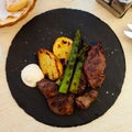 Portion of just cooked beef tenderloin with potatoes and asparagus