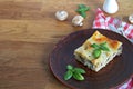 Portion of lasagna with chicken, mushrooms and mozzarella cheese on a brown clay plate. Italian ÃÂuisine Royalty Free Stock Photo