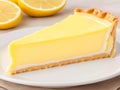 Portion of lemon pie on a white plate in a close up view