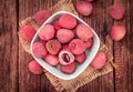 Portion of Lichee Fruits on wooden background selective focus