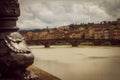 Portion of a luminaire next to the river. Panoramic view of the city of Florence unfocused. Royalty Free Stock Photo