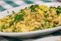 Portion of manioc farofa with eggs, typical Brazilian dish called farofa on green and white checkered tablecloth Royalty Free Stock Photo