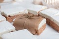 Portion marshmallow with cocoa and cranberries. Wrapped in paper and tied with string. Two-layer zephyr Royalty Free Stock Photo