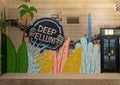 Portion of a mural inside the parking garage of the Novel Apartments featuring the historic Deep Ellum neon sign.