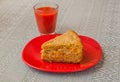 Portion of oat flour cake and glass of tomato juice Royalty Free Stock Photo