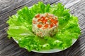 portion of olivier salad with chopped pickles, sausages and vegetables