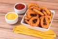 Portion of onion rings on wooden background Royalty Free Stock Photo