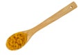 Portion of organic elbow macaroni on a wood spoon