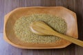 Portion of raw brown rice, wooden bowl, wooden table top view Royalty Free Stock Photo