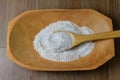 Portion of raw whole wheat flour, wooden bowl, wooden table top view Royalty Free Stock Photo