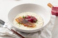 Portion of rice porridge with banana and jam