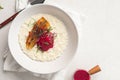 Portion of rice porridge with banana and jam