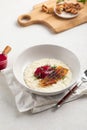 Portion of rice porridge with banana and jam