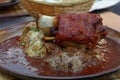 Portion of roasted pork shank with dumplings Royalty Free Stock Photo