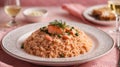 portion of salmon risotto in an embroidered plate on a pink tablecloth