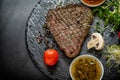 Portion of seasoned grilled steak with sprouts