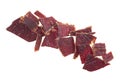 Portion of sliced and dried meat isolated on white background, top view. Pile of beef jerky pieces Royalty Free Stock Photo