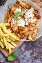 Portion of kebab Chicken duner gyros with french fries and garlic sauce on wooden board Royalty Free Stock Photo
