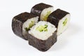Portion of sushi with avocado and cucumber on white background close up. Royalty Free Stock Photo