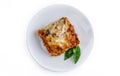 Portion of tasty lasagna, isolated on white Royalty Free Stock Photo