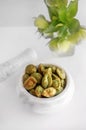 portion of Wasabi peanuts close-up on a light background. Wasabi nuts are in a mortar for grinding Royalty Free Stock Photo