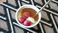 A portion yoghurt with frozen strawberries and cinnamon powder for diet