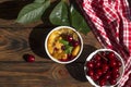 A portioned plate with clafoutis on a wooden background on a bright sunny day. Traditional French pie with cherry Royalty Free Stock Photo