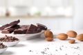 Portions and chocolate chips on containers with almonds in kitchen Royalty Free Stock Photo