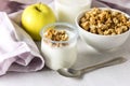 Portions of Fresh Natural Homemade Organic Yogurt Bowl of Granola Raw Apple Napkin Glass of Milk Breakfast Concept