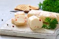 Portions of Herb Butter with pieces of sweet pepper for sandwiches and steaks sliced on a wooden board. Homemade italian food