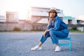 Portirat young asian girl wear Jean ant hat.Old town background