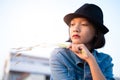 Portirat young asian girl wear Jean ant hat.Old town background