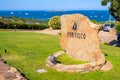 Portisco, Sardinia, Italy - Welcome stone and sign of yacht marina and port of Portisco resort town - Marina di Portisco - at