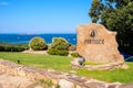 Portisco, Sardinia, Italy - Welcome stone and sign of yacht marina and port of Portisco resort town - Marina di Portisco - at