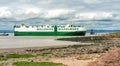 Portishead beach from Esplanade Road with passing large vehicle carrier in the background, UK