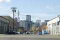 Portland, Oregon / USA - Circa 2019: Homeless tents on the sidewalk next to a street and Portland Oregon city skyline seen in the