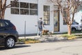 Portland, Oregon / USA - Circa 2019: A male individual walking his dogs on the sidewalk on a beautiful day