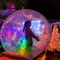 A girl in a costume of a unicorn dancing inside a huge ball at the Miracles of Million lights show
