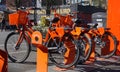 Rack of bike share bicycles in downtown Portland, Oregon, with a Keep Portland Weird sign in the background