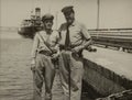 Portly Italian soldiers on the dock in the 1960s
