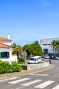 Porto da Cruz, Madeira, Portugal - Sep 24, 2019: Street of the picturesque Portuguese village on a vertical photo. Houses, people