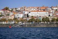 Porto panoramic landmark with boats on sunny day. Old buildings with brick roofs by river Douro in Porto, Portugal. Royalty Free Stock Photo