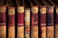 Antique books on vintage bookshelves with old volumes of a library