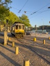 PORTO, PORTUGAL - 5 APRIL 2023: Wooden historical vintage tram moving on Porto street, symbol of city. Old tram passing by in Royalty Free Stock Photo