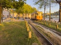 PORTO, PORTUGAL - 5 APRIL 2023: Wooden historical vintage yellow tram 287 moving on Porto street, symbol of city.Old tram passing Royalty Free Stock Photo