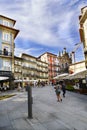 Porto, Portugal. August 12, 2017: Central square of the city with tourists walking and stone floor with many terraces of bars and